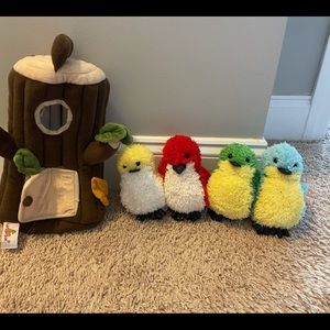 4 stuffed birds with a bird house